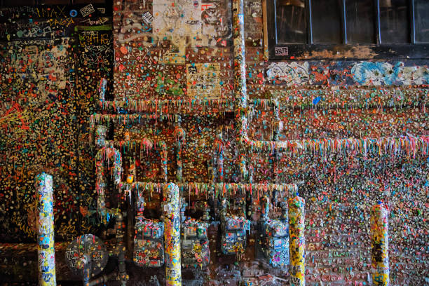 The famous gum wall near Pikes Place market. Brick building covered with colorful gum in an alley. Millions of different colors pieces of gum pressed against the wall in an alley near Pikes Place Market in Seattle, Washington pike place market stock pictures, royalty-free photos & images