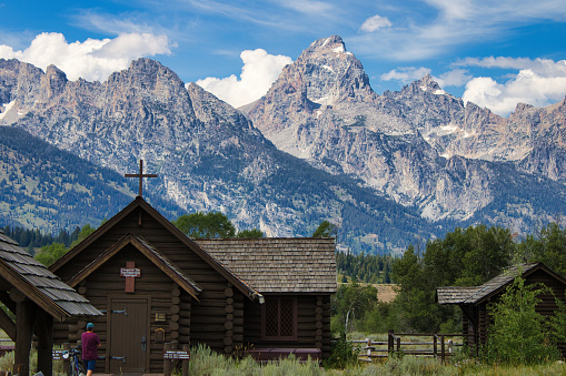 Grand Teton National Park, Wyoming, USA - August 20th, 2022: View of the Chapel of the Transfiguration in front of the Grand Teton mountain range on a summer afternoon