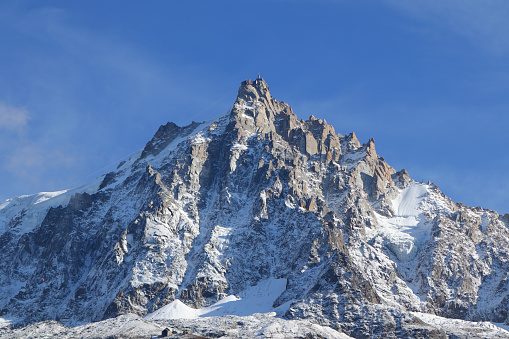 The tallest mountain in Western Europe, Mont Blanc, is captured on a sunny fall day.  The glaciers that have been receding from the warming effects of climate change are visible in the background.