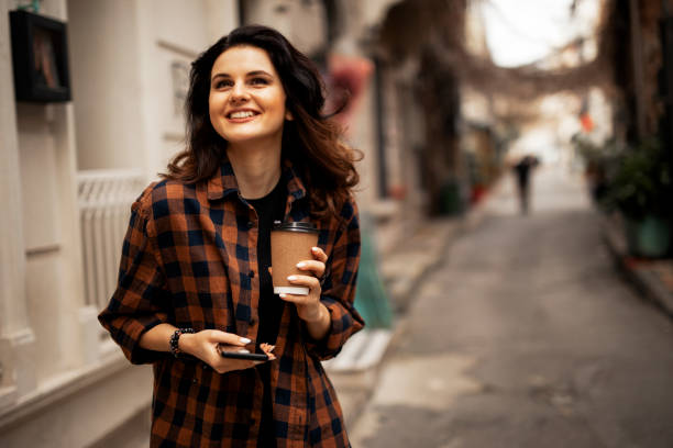 istock Beautiful woman using phone outside 1426329046