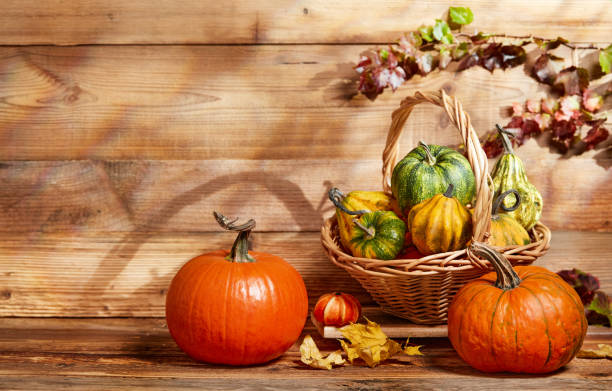 istock Autumn arrangement with pumpkins in a basket 1426329369