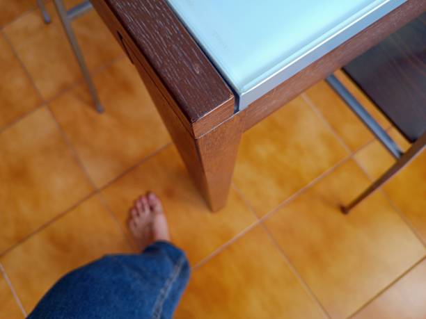 Barefoot at home, mature man near the table, High angle view