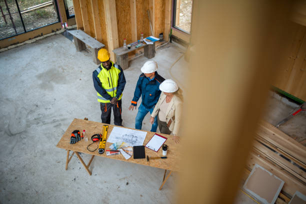 istock Foremen And Real Estate Agent Meet At Construction Site 1426335380
