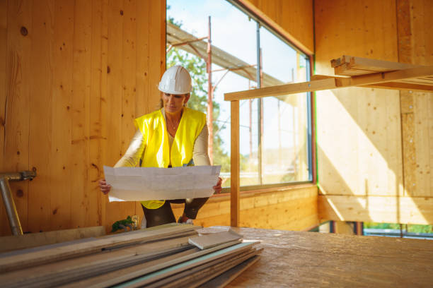 istock Mature Female Engineer Looking At Blueprints Of A Sustainable Home Project 1426335468