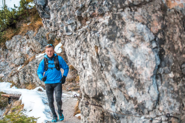 istock An Active Caucasian Male Runner Bounds Up Mountain Trail 1426335727