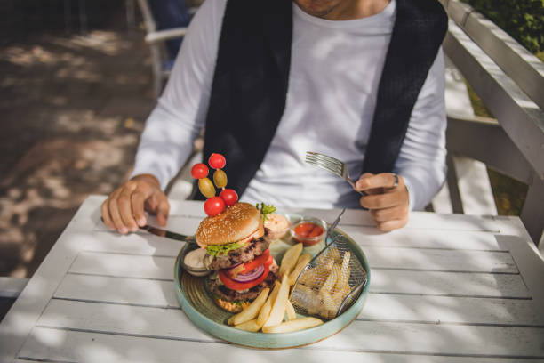 istock I enjoy the taste of this big hamburger 1426337749