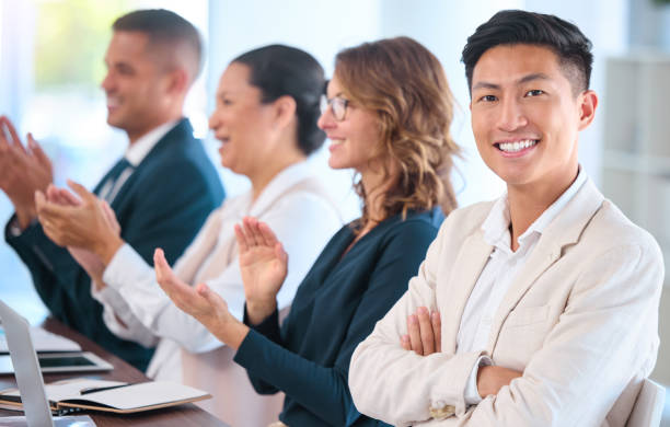 teamwork, motivation and celebration with clapping business people cheering during speech or presentation. portrait of a happy employee enjoying his career while sitting with diverse team in training - training business seminar clapping imagens e fotografias de stock