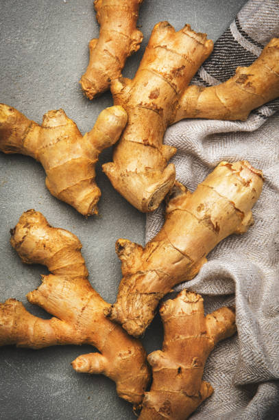 Fresh ginger root. Gray kitchen table background, top view stock photo