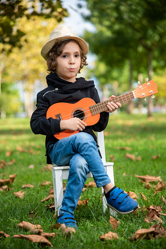 Little boy practicing guitar