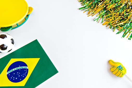 soccer ball, brazilian flag and fan items on white background