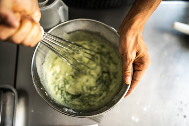 istock Female hands mixing ingredients in a mixing bowl 1426344905
