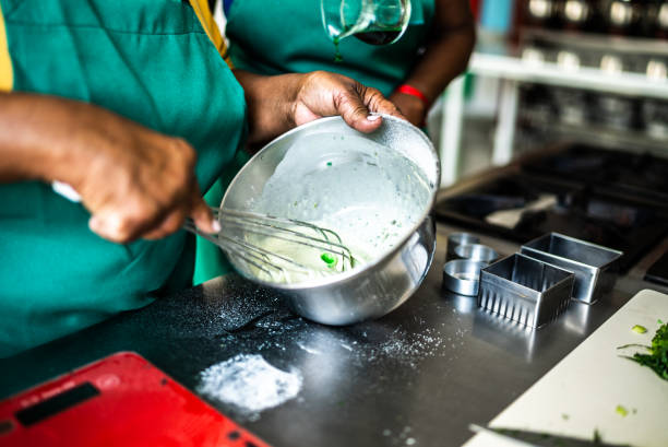 istock Female hands mixing ingredients in a mixing bowl 1426344969
