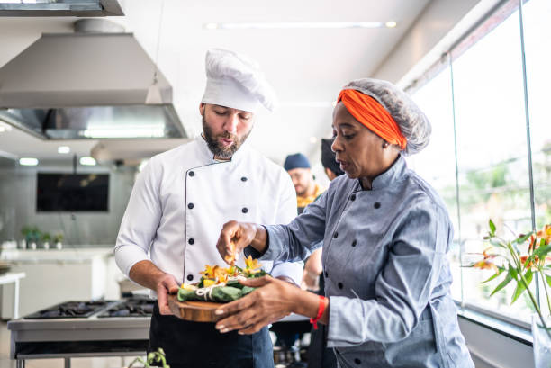 istock Teacher helping a student in a cooking class 1426345981