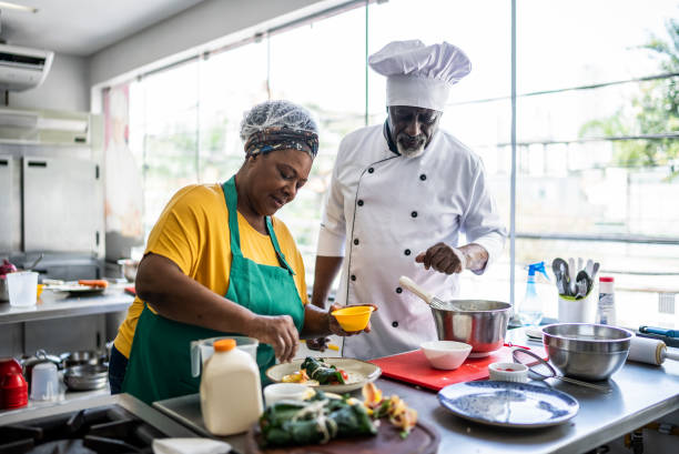 istock Teacher helping a student in a cooking class 1426346050