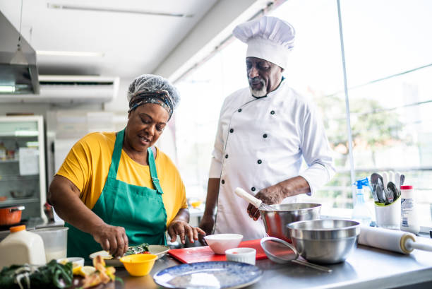istock Teacher helping a student in a cooking class 1426346060