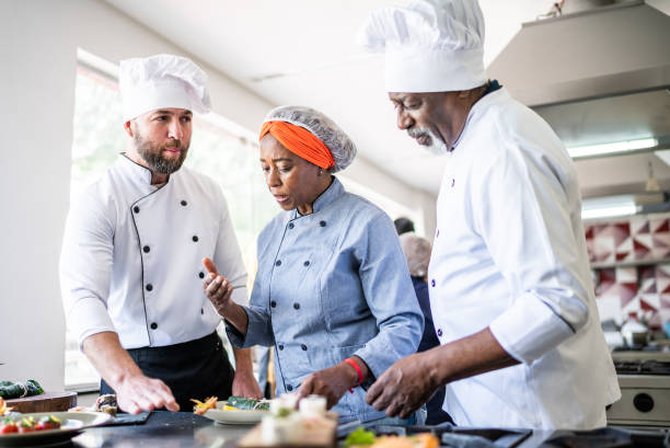 istock Colleagues talking about a dish in the kitchen 1426346627