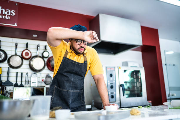 istock Tired mid adult man making pasta in the kitchen 1426346796