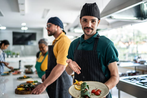 istock Man showing a meal he'd prepared in a cooking class 1426348427