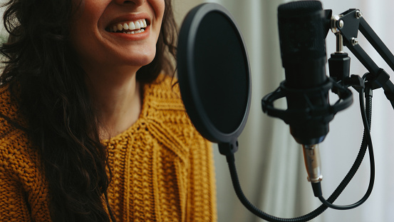 Young woman dubbing voiceover for broadcast stream live show