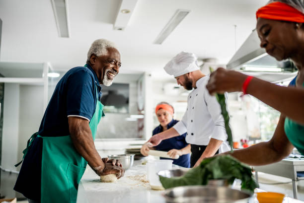 istock Senior man making pasta in a cooking class 1426350403