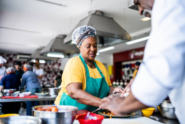 istock Senior woman student cooking during cooking class 1426351501