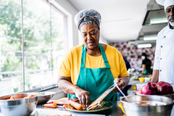 Senior woman cooking on a cooking class