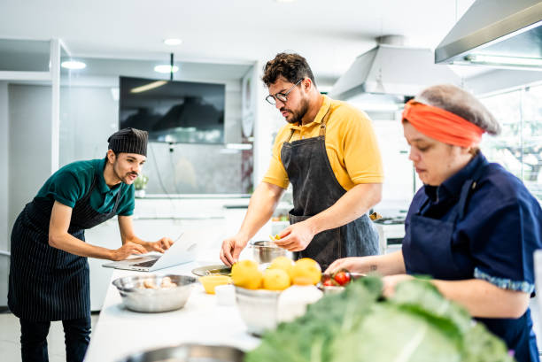 istock Coworkers cooking together in a commercial kitchen 1426352616