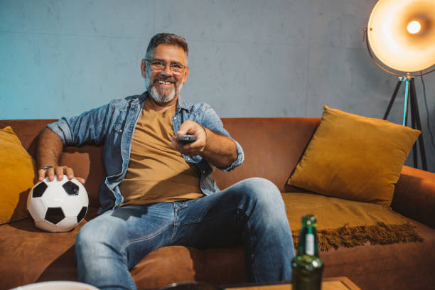 istock Watching soccer game at home 1426352837