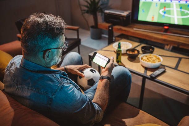 istock Watching soccer game at home 1426353155