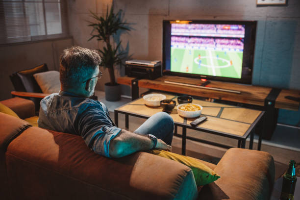 istock Watching soccer game at home 1426353238