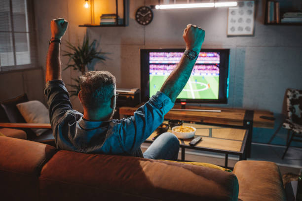 istock Watching soccer game at home 1426353239