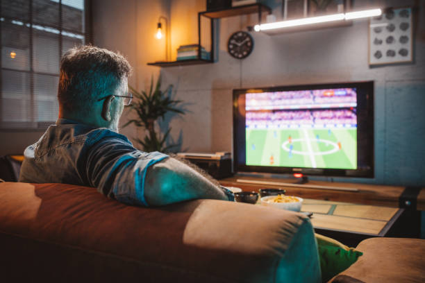 istock Watching soccer game at home 1426353240