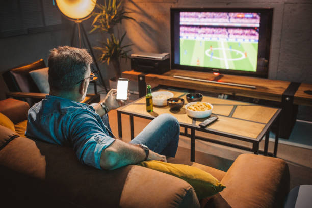 istock Watching soccer game at home 1426353270