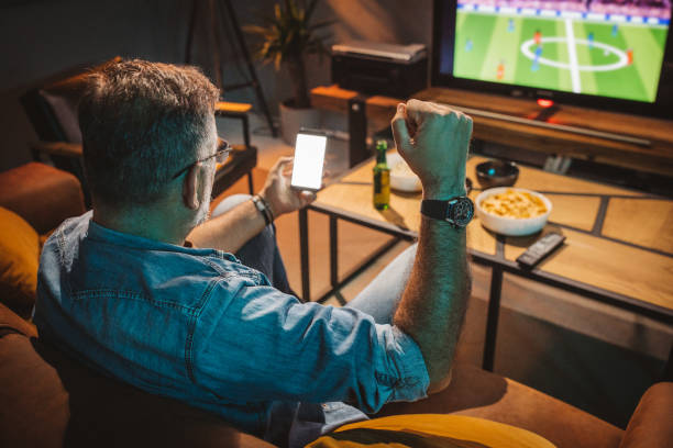istock Watching soccer game at home 1426353276