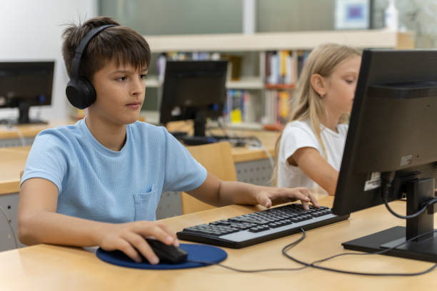 istock Young kids searching for books in the library 1426355252