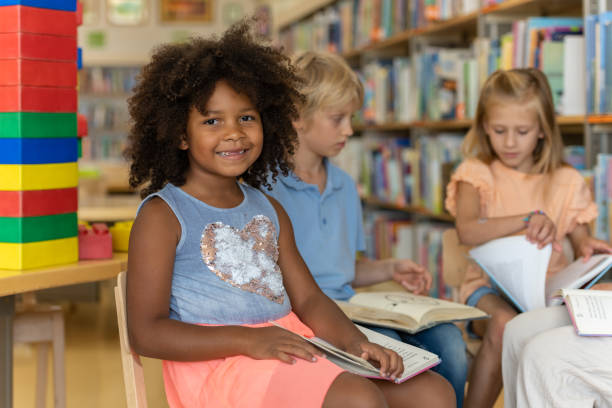 Young kids searching for books in the library