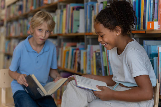 istock Young kids searching for books in the library 1426355831