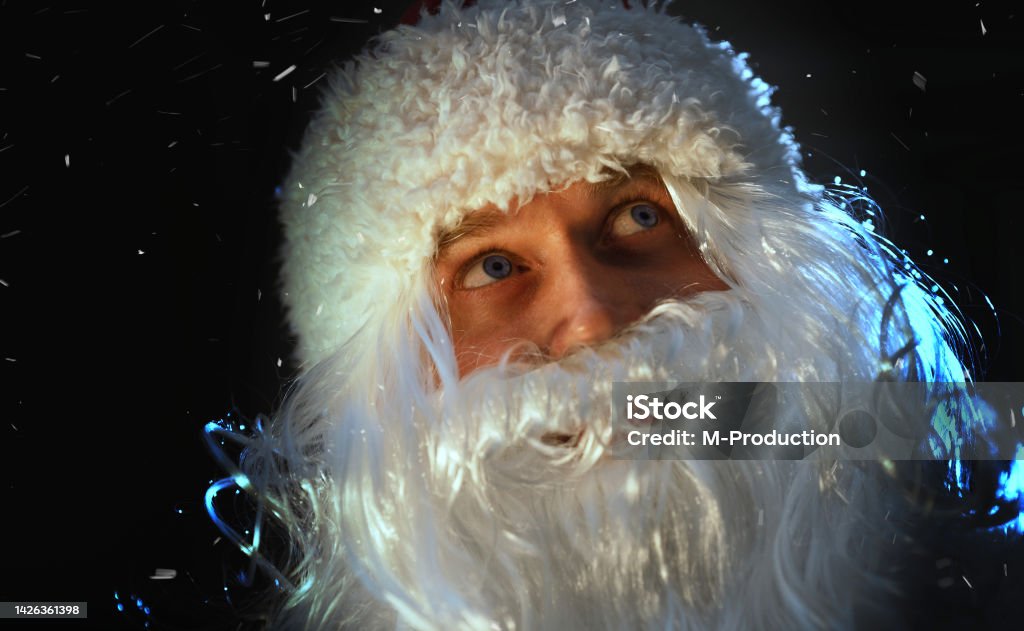 Portrait of Santa Claus looking at the falling snow. 35-39 Years Stock Photo