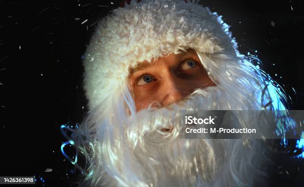 Portrait Of Santa Claus Looking At The Falling Snow Stock Photo - Download Image Now
