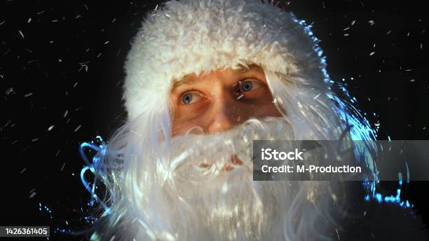 Portrait Of Santa Claus Looking At The Falling Snow Stock Photo - Download Image Now