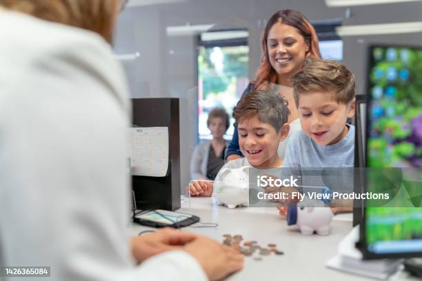Mom Teaching Her Sons About Financial Responsibility Stock Photo - Download Image Now