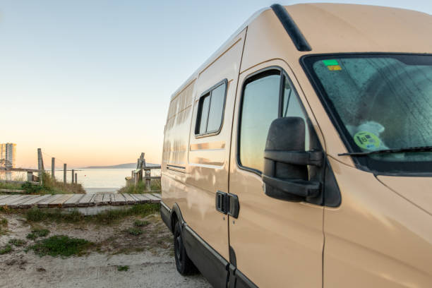 Camper van parked on the beach stock photo