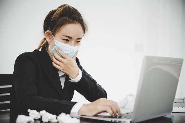 istock Sick young asian business woman wearing protective face mask 1426371011