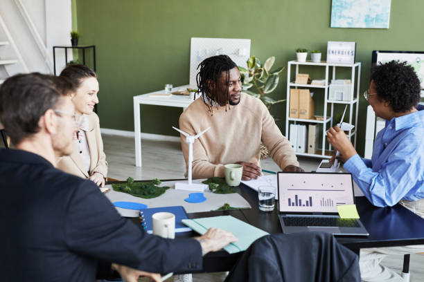istock Group of engineers discussing project at meeting 1426373428