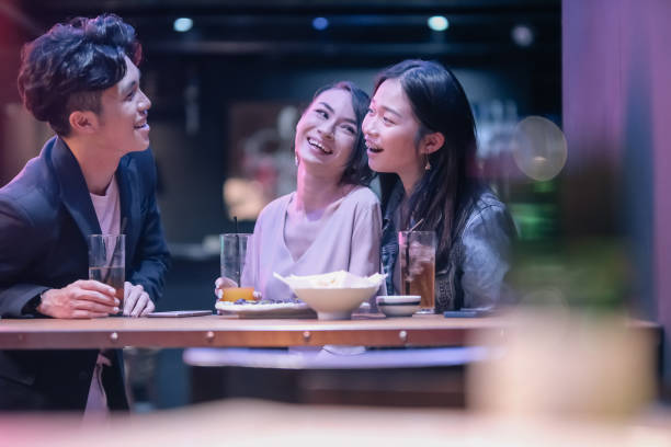 istock group of friends hanging out at pub 1426384059