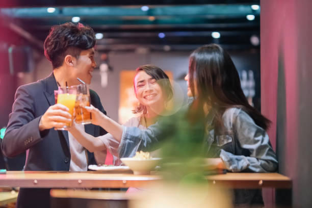 istock group of friend hanging out at pub 1426384445