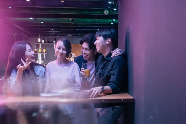 istock group of friend hanging out at pub 1426384488