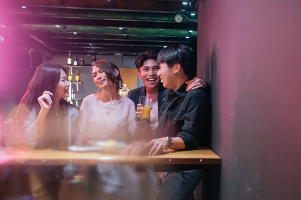 istock group of friend hanging out at pub 1426384490