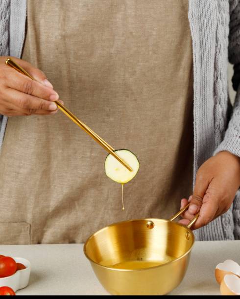istock Process Making Hobak Jeon Korean Green Zucchini Pancake. Coating Sliced Zucchini with Eggs using Gold Chopstick. 1426387784