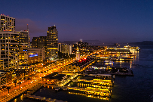 Aerial view of the Ferry Building and the San Francisco Skyline at night.